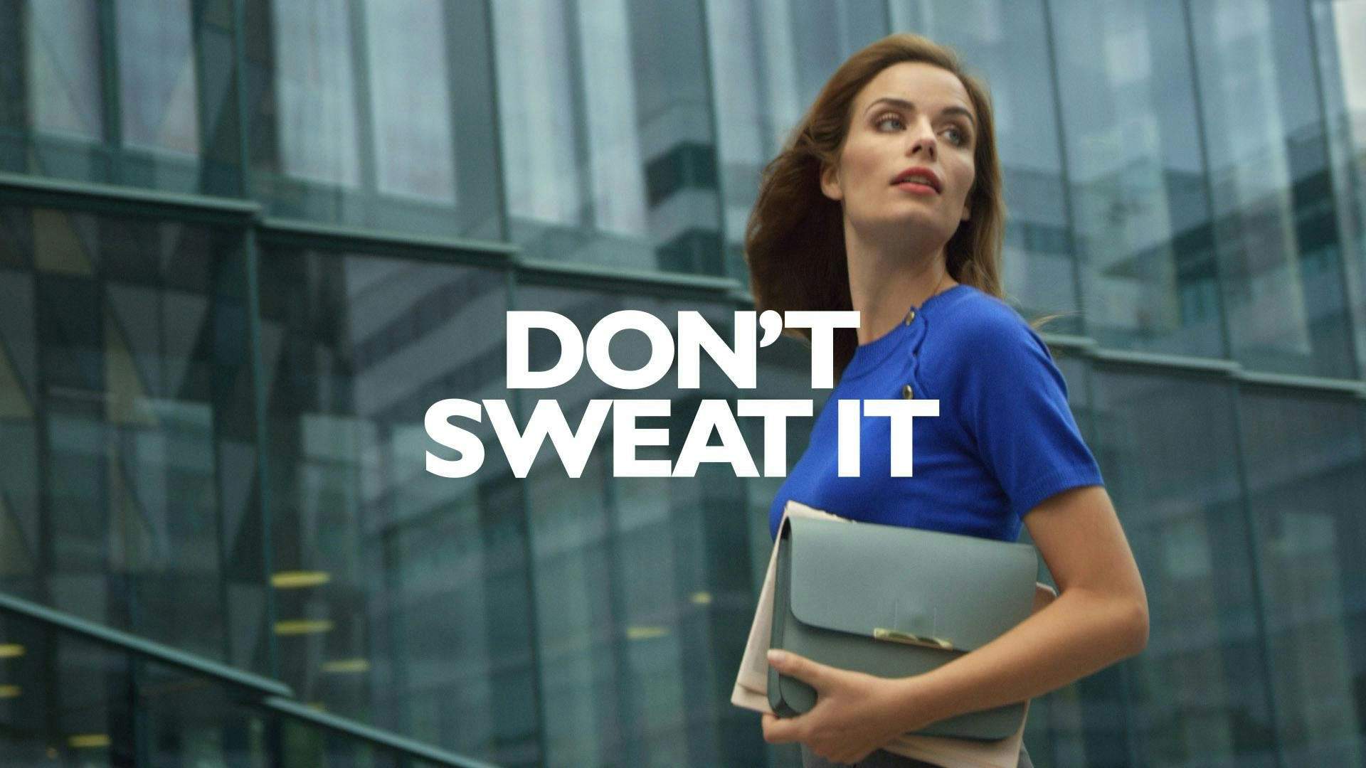 A live action shot of a woman wearing a blue dress and a gray handbag. The tagline "Don't sweat it".